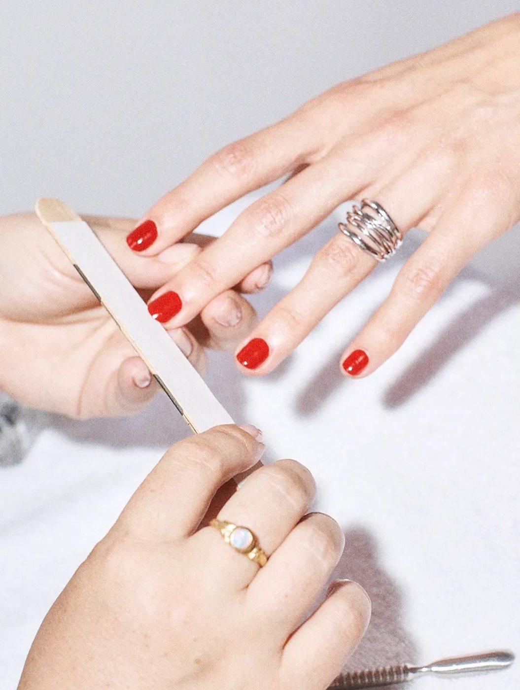 Nagelbehandling med filning och röd manikyr